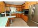 Kitchen with wooden cabinets, stainless steel appliances and view of the backyard at 1405 Periwinkle Ave, Deland, FL 32724