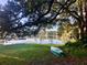 Scenic lake view with a canoe on the bank, showcasing the natural beauty and tranquil setting at 1405 Periwinkle Ave, Deland, FL 32724