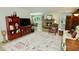 Inviting living room with fireplace, decorative rug and views into the backyard at 1405 Periwinkle Ave, Deland, FL 32724