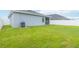 Well-kept backyard with a lush lawn and white privacy fence at 141 Sandestin Dr, Haines City, FL 33844