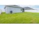 Large, grassy backyard with a privacy fence, perfect for outdoor activities at 141 Sandestin Dr, Haines City, FL 33844