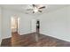 Spacious bedroom featuring a ceiling fan, neutral walls, and an ensuite bathroom at 141 Sandestin Dr, Haines City, FL 33844
