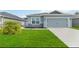 Charming single-Gathering home with a well-maintained lawn and a two-car garage at 141 Sandestin Dr, Haines City, FL 33844