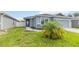 Charming one-story home featuring a two-car garage, well manicured lawn, and tasteful landscaping at 141 Sandestin Dr, Haines City, FL 33844