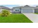 Charming one-story home featuring a two-car garage, well manicured lawn, and tasteful landscaping at 141 Sandestin Dr, Haines City, FL 33844