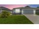 Charming one-story home featuring a two-car garage, well manicured lawn, and tasteful landscaping at 141 Sandestin Dr, Haines City, FL 33844