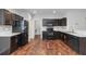 Charming kitchen features dark wood cabinets, stylish countertops, and modern black appliances at 141 Sandestin Dr, Haines City, FL 33844