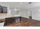 Open kitchen has dark wood cabinets, modern appliances, and a seamless connection to the living area at 141 Sandestin Dr, Haines City, FL 33844