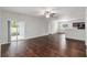 Spacious living room featuring hardwood floors and sliding glass doors to the backyard at 141 Sandestin Dr, Haines City, FL 33844