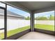 Screened-in patio offering a serene view of the backyard and surrounding landscape at 141 Sandestin Dr, Haines City, FL 33844