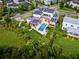 Aerial view of a modern home with a backyard pool, solar panels, and green landscaping at 14106 Eliot Ave, Orlando, FL 32827