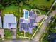Aerial view of a modern home showcasing solar panels, landscaping, and surrounding neighborhood at 14106 Eliot Ave, Orlando, FL 32827