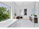 Bright modern bathroom with soaking tub by the window, walk-in shower, and dual vanity sinks at 14106 Eliot Ave, Orlando, FL 32827