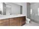 Modern bathroom with double sink vanity, stylish lighting, and a large glass enclosed shower at 14106 Eliot Ave, Orlando, FL 32827