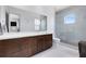 Modern bathroom features a double vanity, a glass-enclosed shower, and clean, contemporary design at 14106 Eliot Ave, Orlando, FL 32827