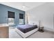 Stylish bedroom features a blue accent wall, modern lighting, and a comfortable bed at 14106 Eliot Ave, Orlando, FL 32827