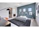 This bedroom boasts modern decor, including unique accents, wall art, and open bathroom entrance at 14106 Eliot Ave, Orlando, FL 32827