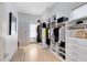 Spacious walk-in closet featuring built-in shelving, drawers, and hanging racks for optimal organization at 14106 Eliot Ave, Orlando, FL 32827