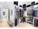 Large walk-in closet with custom shelving, hanging space, and storage for shoes, bags, and luggage at 14106 Eliot Ave, Orlando, FL 32827