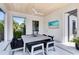 Covered outdoor dining area featuring a wood plank ceiling, flat screen TV, and view of the backyard oasis at 14106 Eliot Ave, Orlando, FL 32827