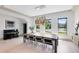 Bright dining room with large windows, a modern chandelier, and a grand piano, creating a sophisticated and inviting atmosphere at 14106 Eliot Ave, Orlando, FL 32827