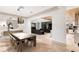 Open-concept dining area with stylish lighting, modern decor, and seamless access to the living area and kitchen at 14106 Eliot Ave, Orlando, FL 32827
