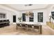 Well-lit dining space featuring a long table with modern chairs, complemented by unique lighting and elegant decor accents at 14106 Eliot Ave, Orlando, FL 32827