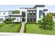 Modern home with manicured front yard and contemporary design, offering an appealing curb appeal at 14106 Eliot Ave, Orlando, FL 32827