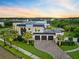 Beautiful modern home with a three-car garage, brick driveway, and a meticulously landscaped front yard at 14106 Eliot Ave, Orlando, FL 32827