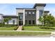 Modern home with a well-manicured front yard and contemporary architectural details at 14106 Eliot Ave, Orlando, FL 32827