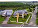 View of a modern two-story home with contemporary design elements, a manicured lawn, and solar panels at 14106 Eliot Ave, Orlando, FL 32827