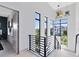 Bright hallway features modern railing, hardwood floors and view of exterior at 14106 Eliot Ave, Orlando, FL 32827