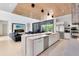 Modern kitchen featuring an expansive island, stainless steel appliances, and a seamless flow into the inviting living area at 14106 Eliot Ave, Orlando, FL 32827