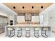 Contemporary kitchen featuring a large island with seating, custom cabinetry, and modern appliances at 14106 Eliot Ave, Orlando, FL 32827