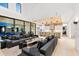 Bright and open living area featuring a sleek gray sofa and access to an outdoor pool area through large sliding glass doors at 14106 Eliot Ave, Orlando, FL 32827