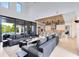 Stunning living room with a large gray sofa and an open floor plan that flows seamlessly into the modern kitchen at 14106 Eliot Ave, Orlando, FL 32827