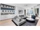 Open concept living room with modern decor, custom shelves and lots of natural light at 14106 Eliot Ave, Orlando, FL 32827