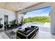 Open patio with comfortable seating overlooking a pristine pool and lush greenery at 14106 Eliot Ave, Orlando, FL 32827