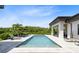 Beautiful backyard pool with lounge chairs and tropical landscaping, perfect for relaxation at 14106 Eliot Ave, Orlando, FL 32827