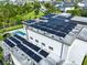 Aerial view of home's roof completely fitted with solar panels over the outdoor living area and pool at 14106 Eliot Ave, Orlando, FL 32827