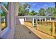 Spacious wooden deck overlooking a lush backyard with new railing for outdoor enjoyment and easy access at 1510 Live Oak St, New Smyrna Beach, FL 32168
