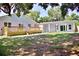 Spacious backyard featuring a small wooden deck and covered patio attached to the home at 1510 Live Oak St, New Smyrna Beach, FL 32168