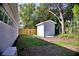 The backyard features lush grass, a shed, and a privacy fence at 1510 Live Oak St, New Smyrna Beach, FL 32168