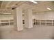 A spacious basement is equipped with utility hookups and shelving for storage, perfect for various needs at 1510 Live Oak St, New Smyrna Beach, FL 32168
