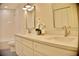 A clean, modern bathroom features double sinks, quartz countertops, updated fixtures, and a well-lit mirror at 1510 Live Oak St, New Smyrna Beach, FL 32168