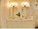 Modern bathroom features double sinks, elegant lighting, and a marble-tiled shower at 1510 Live Oak St, New Smyrna Beach, FL 32168