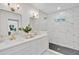 Bathroom featuring dual sinks, vanity, frameless shower and stylish finishes at 1510 Live Oak St, New Smyrna Beach, FL 32168