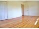 A bright, airy room boasts hardwood floors, fresh paint, and a spacious closet for ample storage at 1510 Live Oak St, New Smyrna Beach, FL 32168