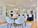 Open dining area featuring a round table, stylish chairs, and modern chandelier at 1510 Live Oak St, New Smyrna Beach, FL 32168