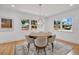 Dining room featuring a round wood table, six chairs, an area rug and three windows at 1510 Live Oak St, New Smyrna Beach, FL 32168